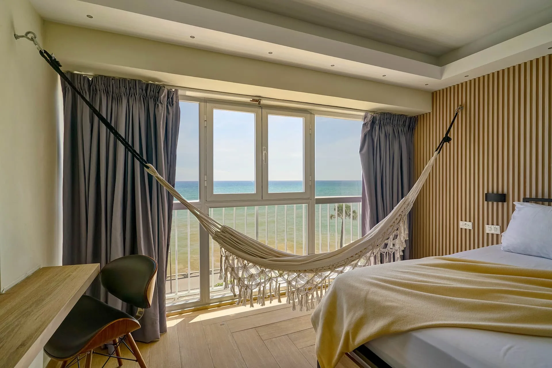 Hammock strung in front of sea-view windows