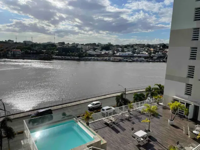 The Ozama River and a rooftop pool seen from the river-view studio