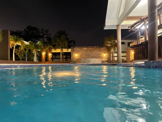 Evening light on the villa pool and palms