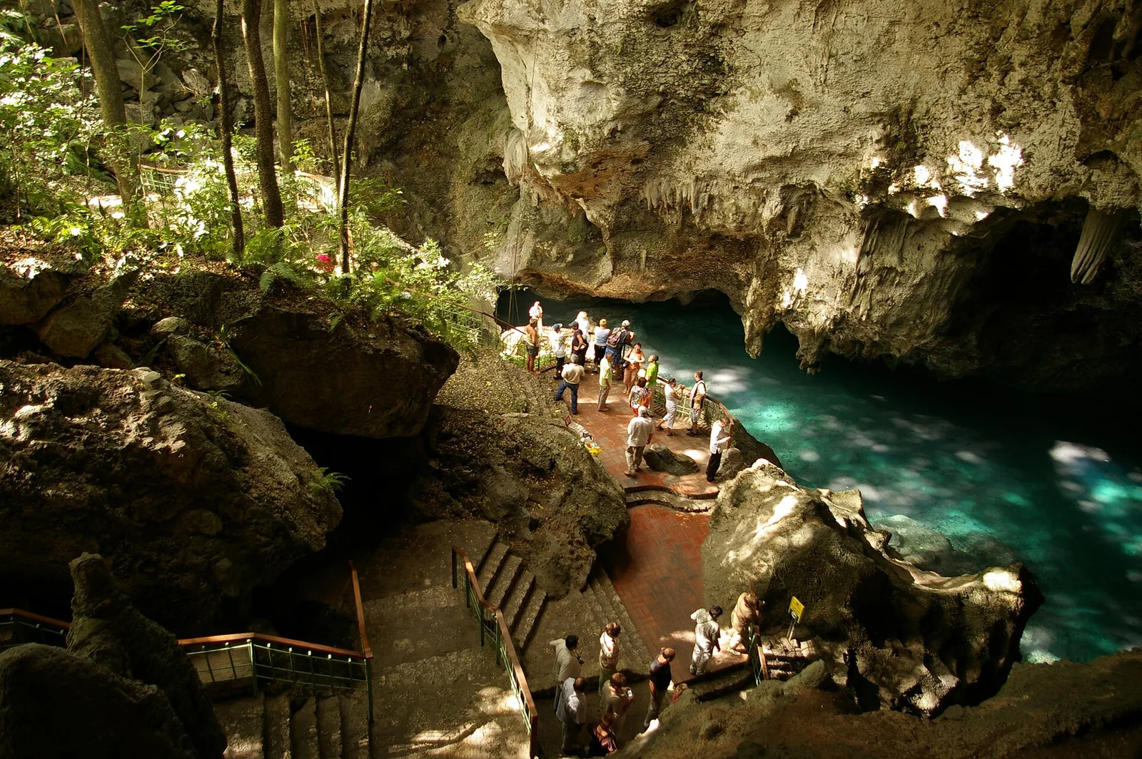 A green pool inside the caves of Los Tres Ojos
