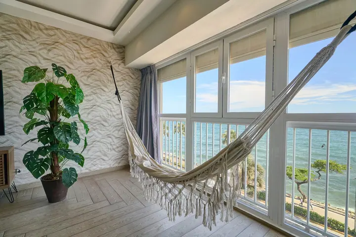 Hammock and a potted plant by windows over the Malecón