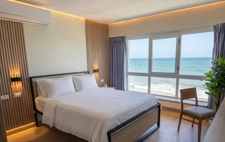 Bedroom with a wood headboard and a sea view
