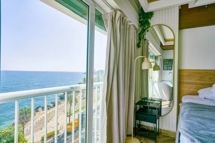 Balcony doors open to the sea in a Potenza studio