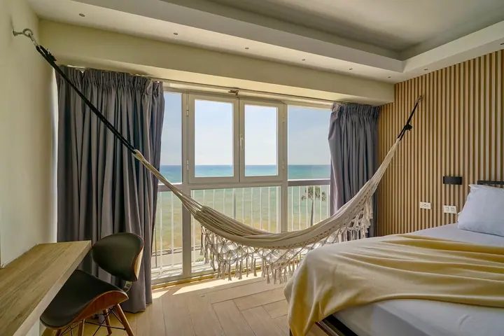 Hammock strung in front of sea-view windows