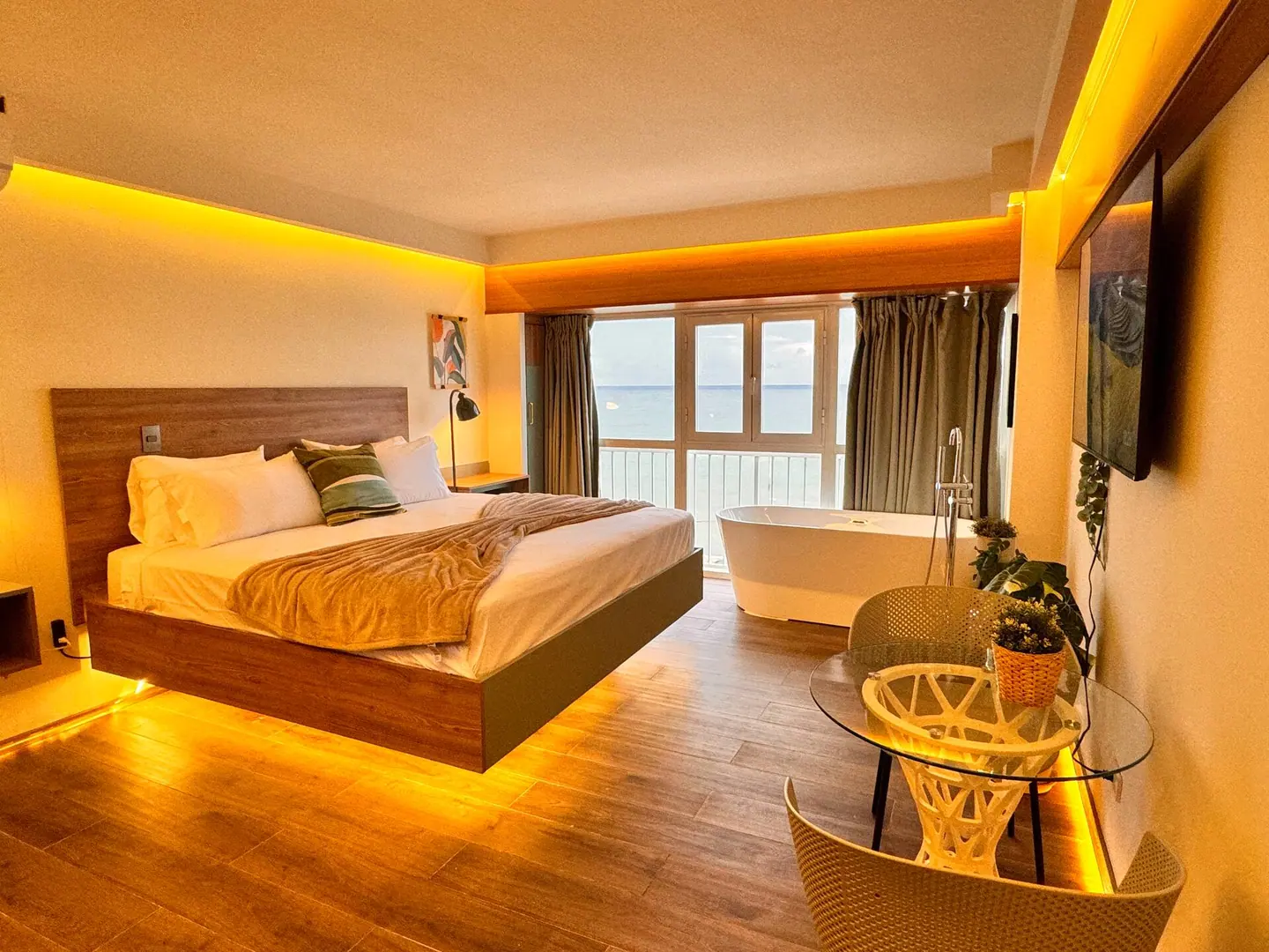 Studio in warm evening light with a floating bed and a tub