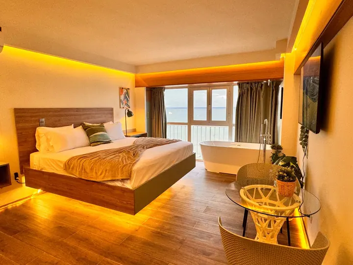 Studio in warm evening light with a floating bed and a tub