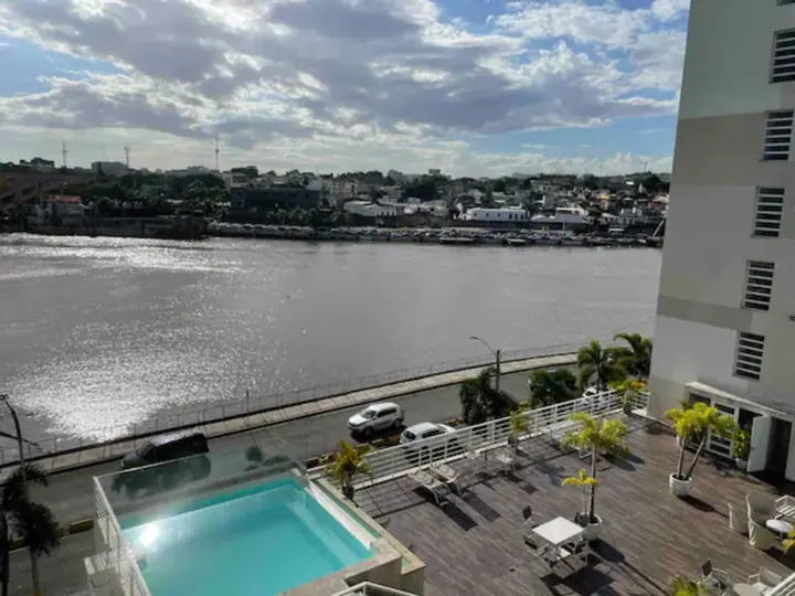 The Ozama River and a rooftop pool seen from the river-view studio